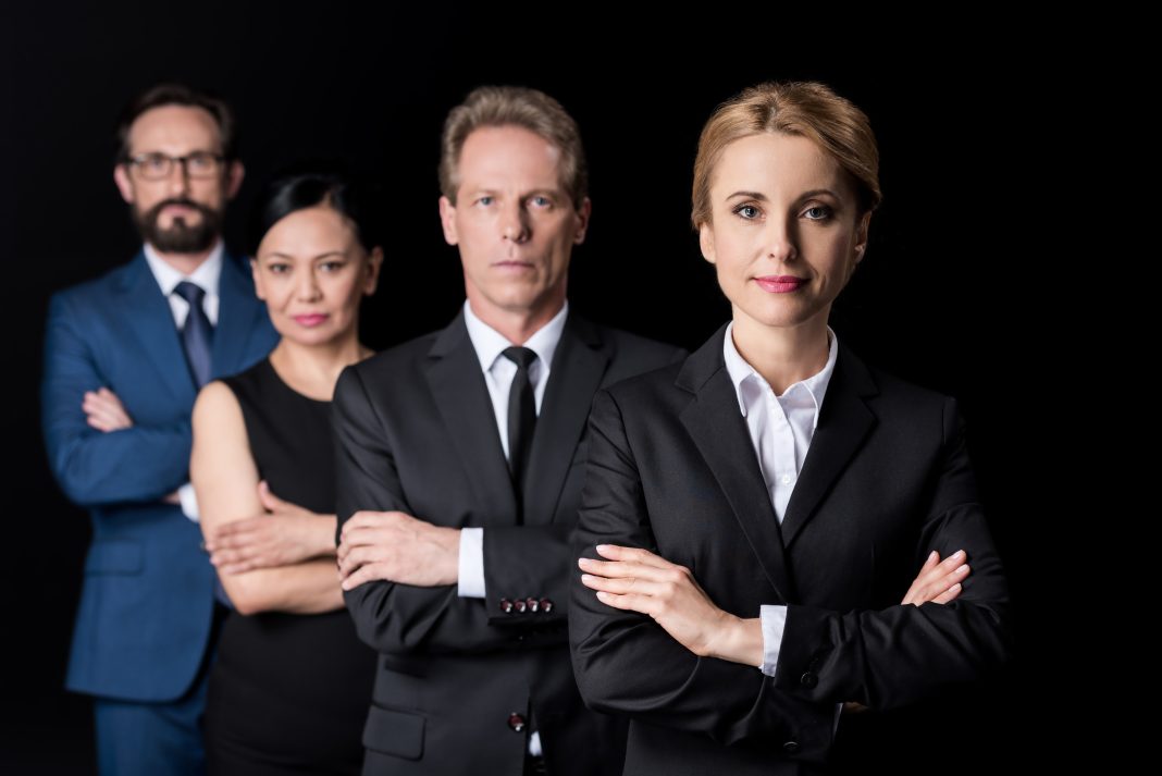 confident multiethnic group of businesspeople standing with crossed arms and looking at camera Family Lawyer in Dubai